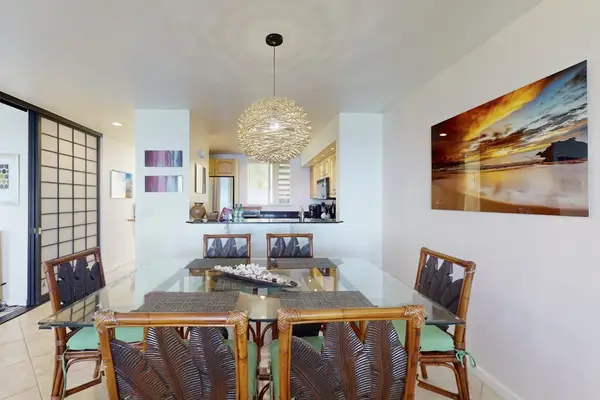 Dining Area with Wooden Table, Seating for 6, Statement Chandelier, and Wall Art