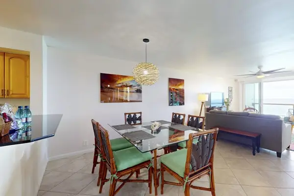 Open-Concept Living & Dining Area Featuring Dining Set for 6 and Adjoining Kitchen Bar
