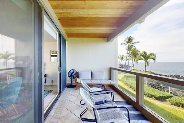 Private Covered Balcony with Patio Seating, Wooden Ceiling Accents, and Scenic Views