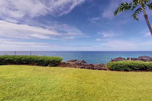 Expansive Ocean View Across Manicured Resort Lawn and Coastal Hedges