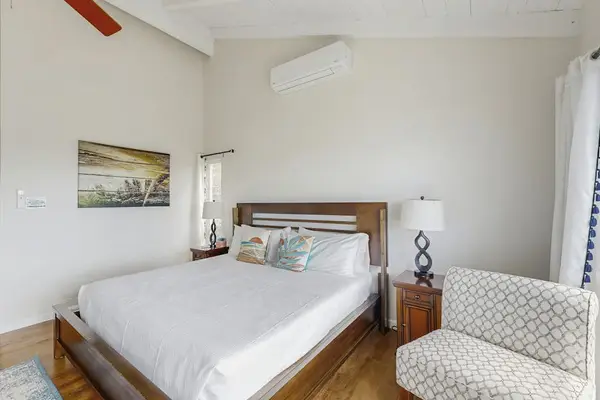 Relax in the comfortable bedroom with a cozy side sitting area.