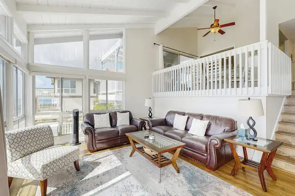 Take in the surrounding views from the comfortable living room’s glass wall.