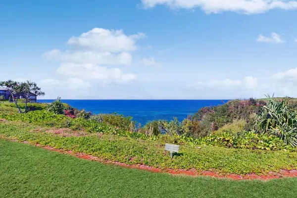 Nearby scenery features verdant valleys, rolling mountains, and sparkling ocean