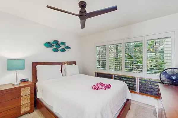 Comfortable sleeping area showcases coordinated decor and soothing natural light