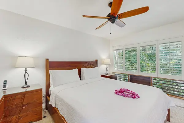 Serene bedroom features layered linens, bedside furnishings, and calming accents