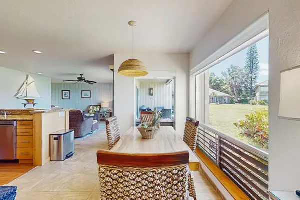 Casual dining area features coordinated furnishings beneath bright natural light