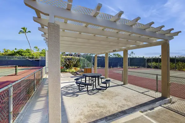 Relax in the shaded seating area just steps from the tennis courts.