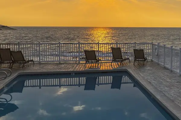 Golden Hour Sunset View over Oceanfront Pool Deck & Seating Area