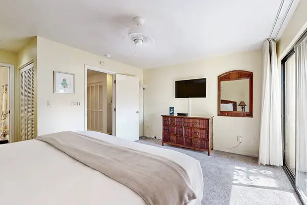 First Bedroom welcomes peaceful sleep beside useful bedside storage nightly