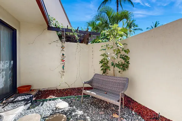 Patio seating creates relaxed gatherings beside colorful tropical garden surroundings