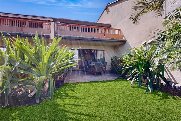 Tropical landscaping surrounds clear resort water with vivid island color