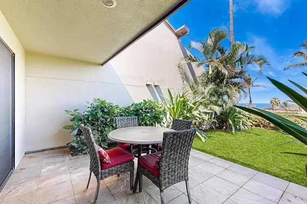 Shaded patio table welcomes leisurely breakfasts surrounded by colorful foliage