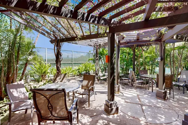 Landscaped walkways guide visitors through vibrant gardens toward shared amenities