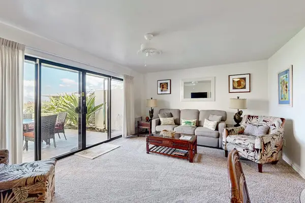 Airy lounge seating invites conversations beside expansive sliding glass doors