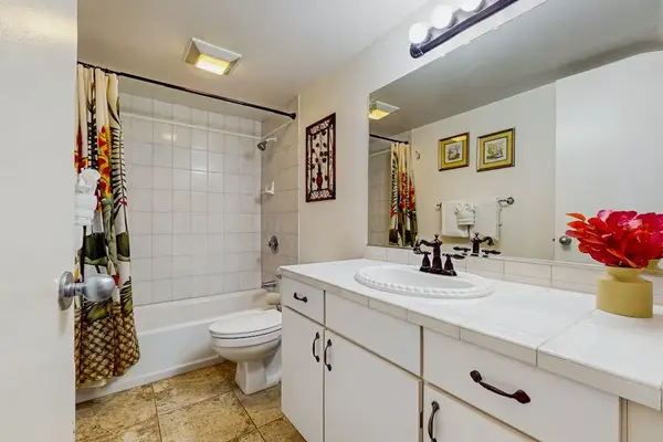 Bright guest bathroom with ample counter space.