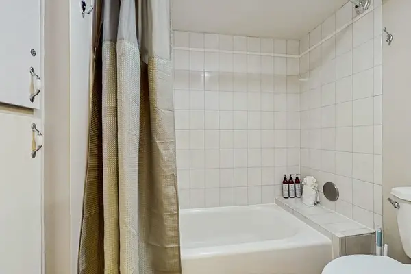 Full guest bathroom with a shower and bathtub.