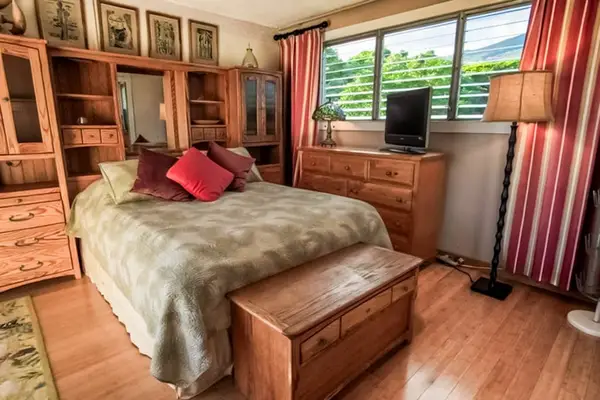 Bedroom features queen bed ceiling fan decor and balcony access