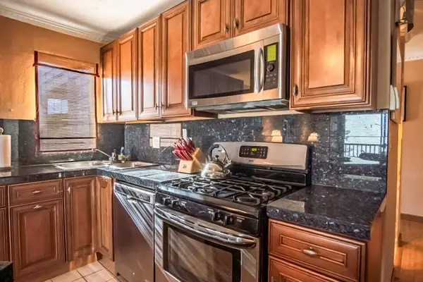 Kitchen includes appliances wood cabinetry range and ample counter space