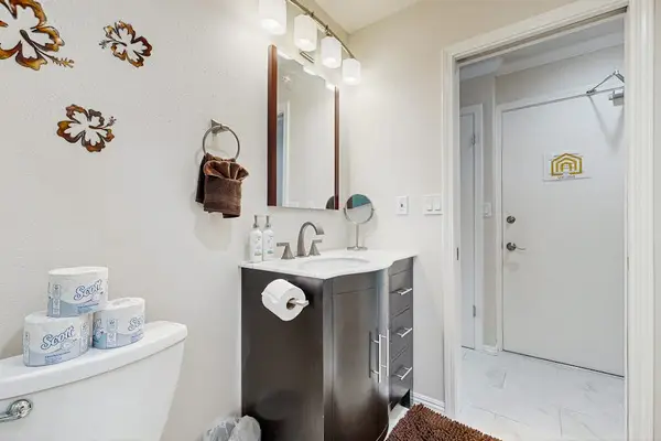Bathroom vanity displays mirror storage baskets and decorative floral accents