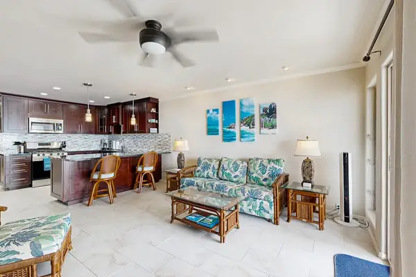 Open living space connects comfortable seating with bright balcony doors