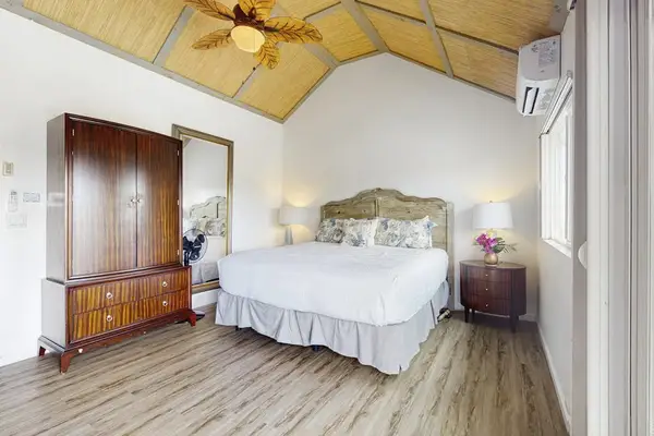 Master bedroom with king bed and vaulted ceilings.