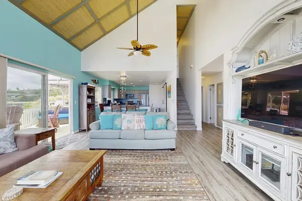 Unwind in front of these floor to ceiling windows in the family room while watching a movie.   There are sliding doors straight out to your lanai allowing in all of the natural light.