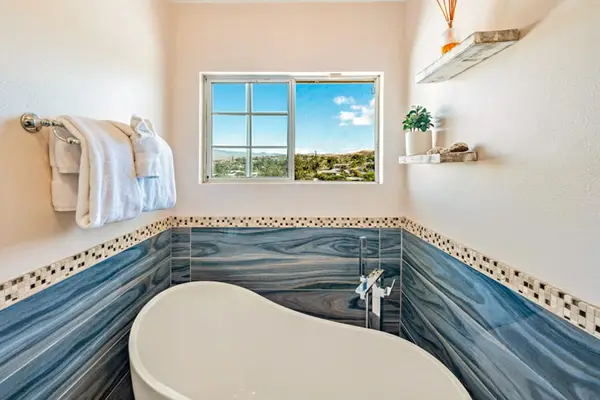 Master bathroom with a large soaking tub and a great window for extra light.