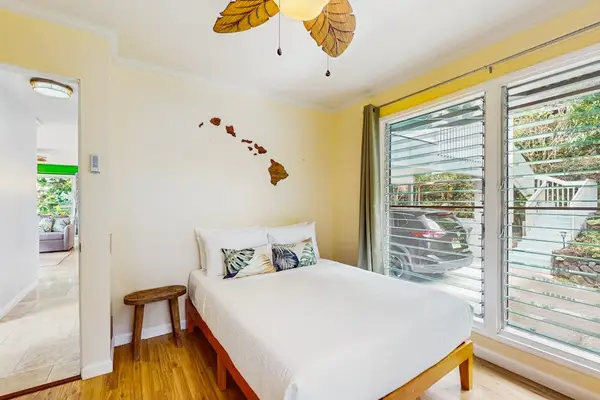 First bedroom offers queen bed natural light and balcony access