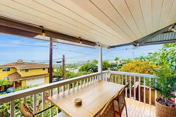 Covered balcony table offers open views and comfortable outdoor dining