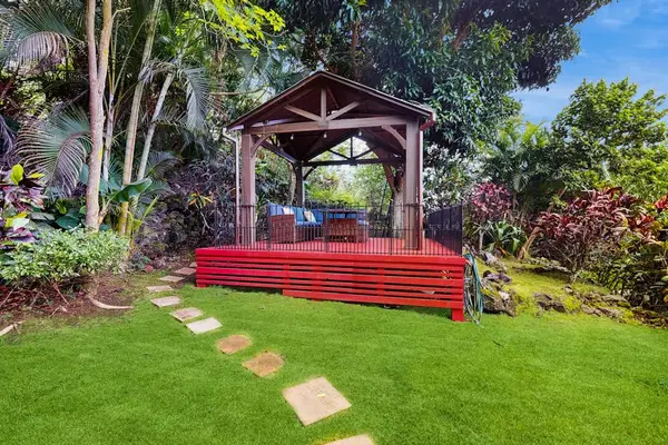 Garden gazebo offers shaded seating surrounded by landscaping and lawns