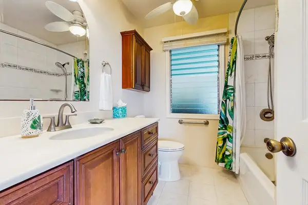 Full bathroom includes vanity mirror shower and convenient storage space