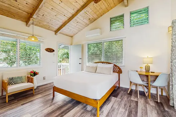 Spacious bedroom with vaulted wood ceiling