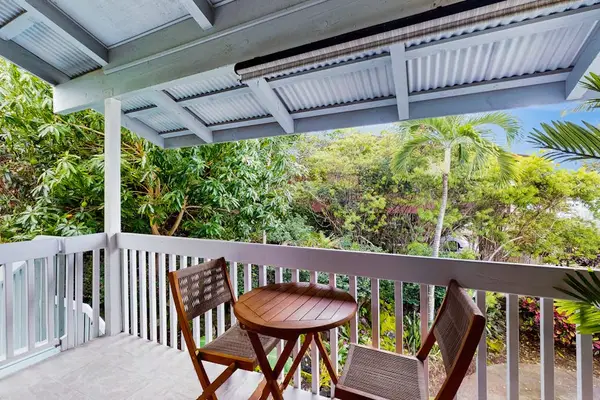 Covered balcony dining table offers garden views and fresh air