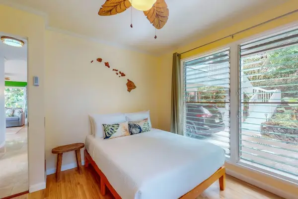 Second bedroom offers double bed bedside table and garden views