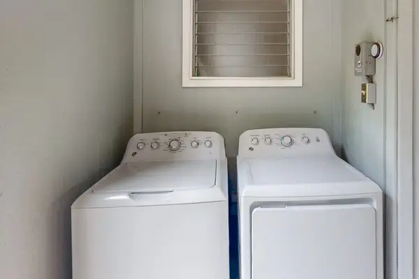 Washer and dryer stand together in a convenient utility area