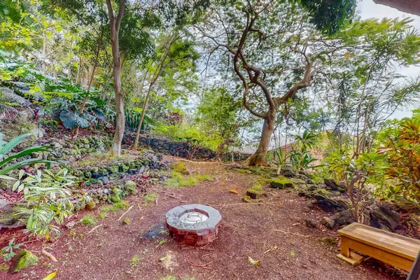Shaded garden seating area creates a peaceful outdoor retreat nearby