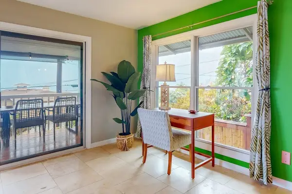 Breakfast nook opens to balcony with seating and garden views