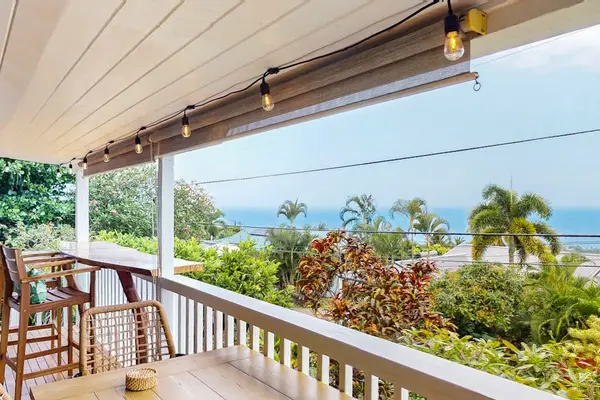 Upper balcony provides outdoor seating with panoramic coastal views nearby