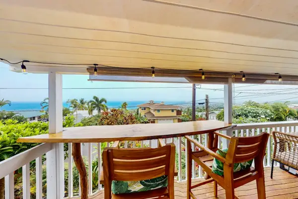 Covered balcony dining aIsland-facing balcony provides dining space and welcoming outdoor viewsrea overlooks island scenery with comfortable seating