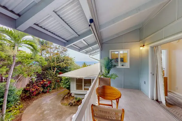 Covered lanai walkway connects indoor rooms with shaded outdoor seating
