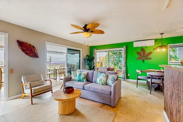 Bright living room showcases colorful decor seating and natural light