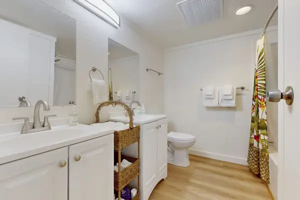 Bright Guest Bathroom Complete With Clean Lines And Plush Towels
