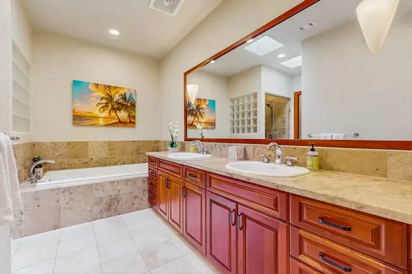 Master bathroom with double sinks, soaking tub and a walk-in shower.