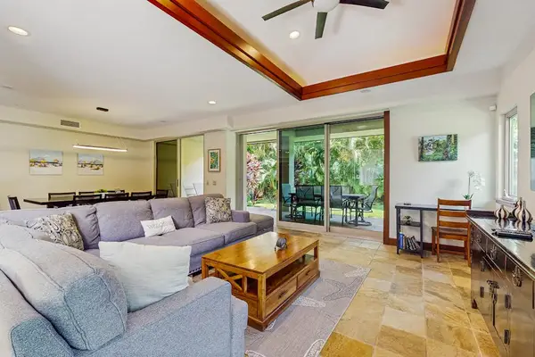 Living Room with plenty of seating with this comfortable sectional and open to the dining room and kitchen in this open floor plan design.  Lots of naturals light from the windows and sliding doors.