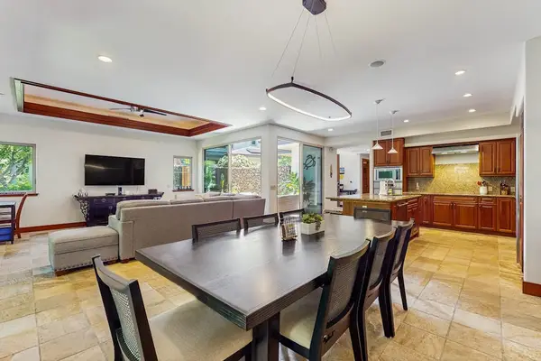 Living Room with plenty of seating with this comfortable sectional and open to the dining room and kitchen in this open floor plan design.