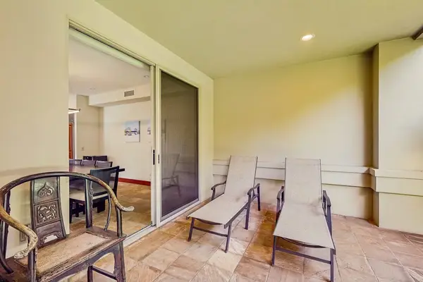 Dine at the nearby table for six, or push back the sliding glass doors and unite the indoors with the outdoors with an additional table and chairs and a wet bar with a gas grill, heating drawers, and a minifridge.
