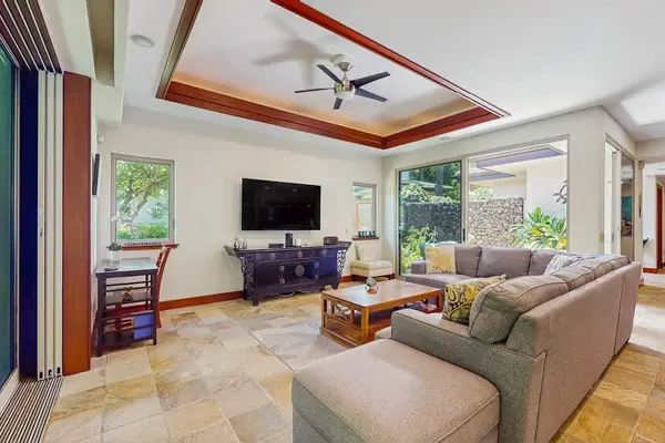 Living Room with plenty of seating with this comfortable sectional and open to the dining room and kitchen in this open floor plan design.