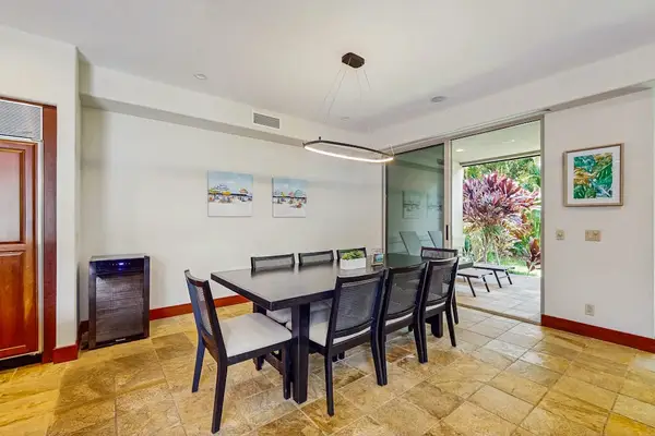 Dine at the nearby table for six, or push back the sliding glass doors and unite the indoors with the outdoors with an additional table and chairs and a wet bar with a gas grill, heating drawers, and a minifridge.