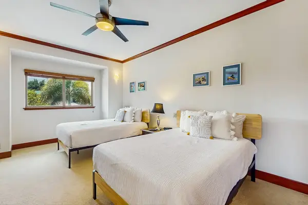 Large guest room with two double beds.