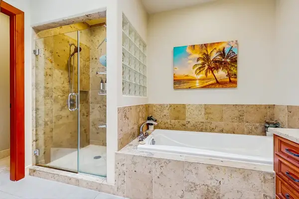 Master bathroom with two sinks, soaking tub and a walk-in shower.